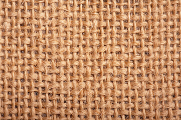 Close-up of natural burlap hessian sacking. Background texture using burlap material.