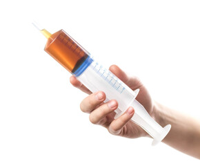 The hand holds a large 160 ml syringe. Close up. Isolated on a white background