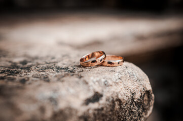Wedding gold rings on stone background