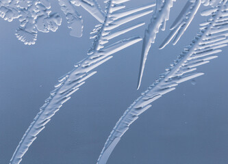 Blue patterns from frost on glass as a background.