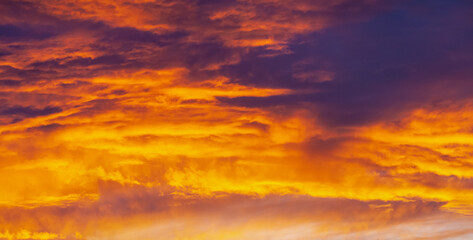 Fototapeta na wymiar Purple and orange sunset with clouds