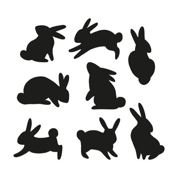 Easter bunny black silhouette collection. Rabbit in different positions clipart set isolated on white background. Farm animals shape design elements.