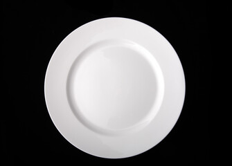 blank white dinner plate isolated on the black background with clipping path.