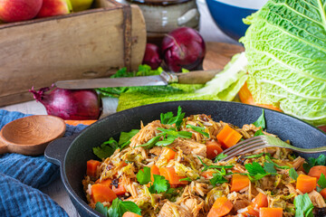 Slow cooked turkey breast with brown rice savoy and carrot vegetables served in a skillet