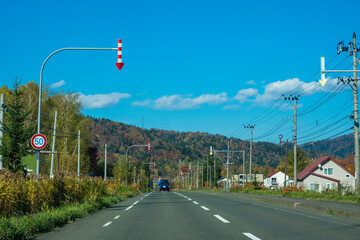 Rural road at autumn in Furano Township, Hokkaido, Japan.