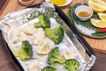 Frozen vegetables broccoli and cauliflower for cooking in foil in oven. Vegan vegetarian healthy diet food 