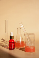 Essence for skin health on a beige  background. laboratory where cosmetics are created.  Unisex cosmetics for men and women. Laboratory research of cosmetics for natural ingredients
