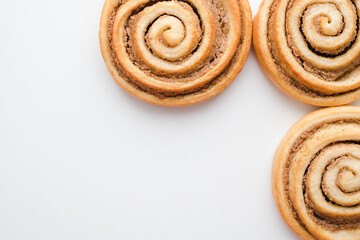 cinnamon buns on a white plate, a snail bun on a white plate