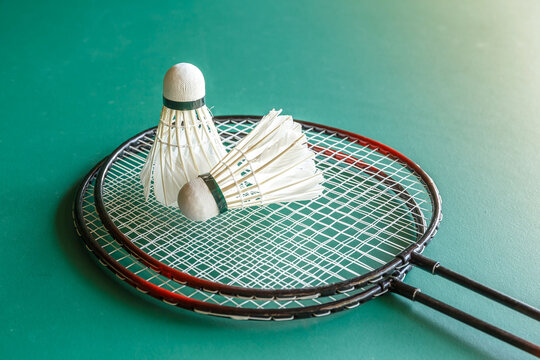 Badminton rackets and shuttlecock on the green table. sport and business concept.