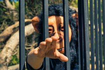 Portrait Of Caged Women With Monkey Mask In Forest