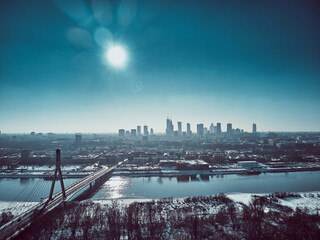 Beautiful panoramic winter aerial drone view to Warsaw city center with skyscrapers and Swietokrzyski Bridge (En: Holy Cross Bridge) - is a cable-stayed bridge over the Vistula river in Warsaw, Poland