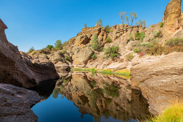Lake Bear Gulch and rock formations in Pinnacles National Park in California, the ruined remains of an extinct volcano on the San Andreas Fault. Beautiful landscapes, cozy hiking trails for tourists