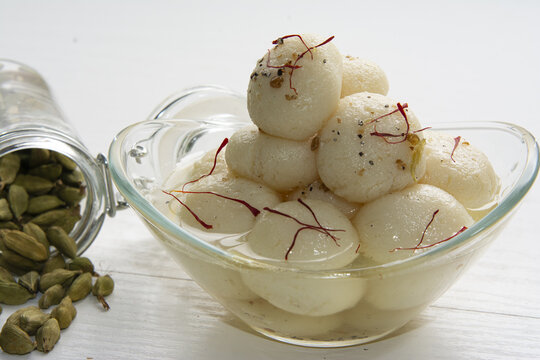 Appetizing ball-shaped dumplings of Rasagulla dessert in light sugar syrup