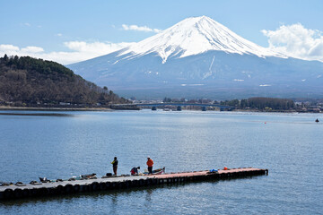 Fishermen fishing on Lake Kawaguchiko with Mount Fuji in the background at Kawaguchiko city, Japan.