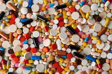 Fototapeta na wymiar top view of a large number of colored tablets, pills and capsules