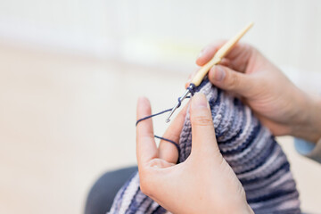 Women are knitting by hand