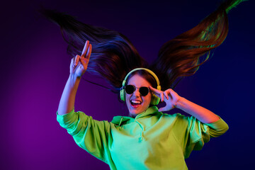Photo of crazy happy cheerful young lady wind blow hair wear headset isolated on gradient neon background