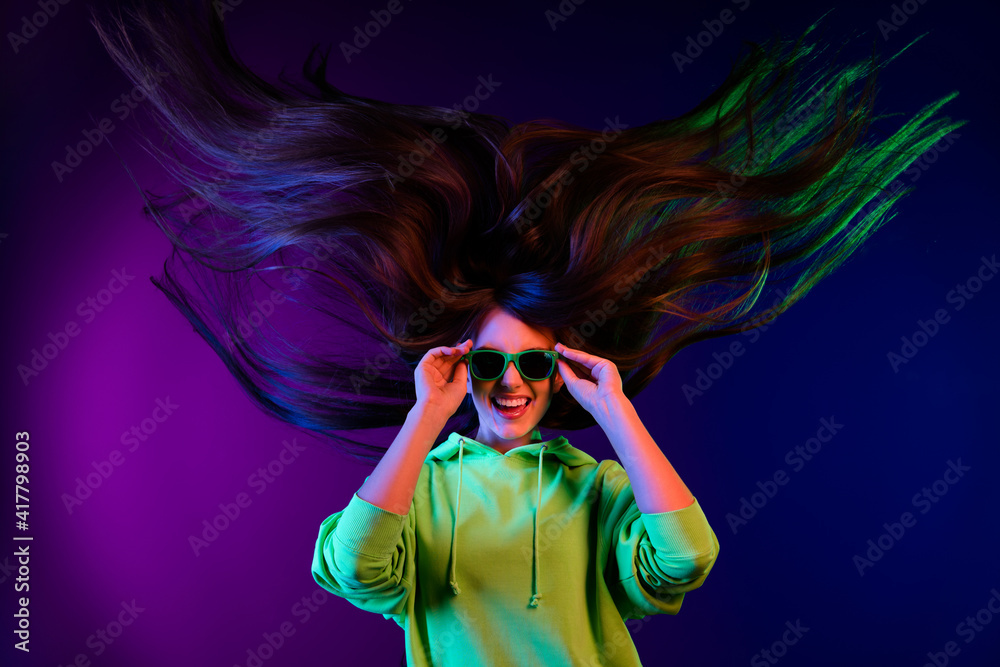 Poster Photo of crazy funky young woman wear sunglass cool long hair fly wind isolated on colorful gradient background