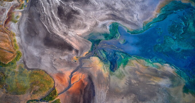 Dry lake or swamp in the process of drought and lack of rain or moisture, a global natural disaster - aerial drone view