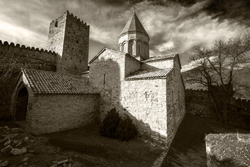 old castle in the evening landscape in black and white with dramatic sky 