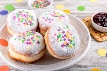 Obraz na płótnie Canvas Carnival sprinkled doughnuts and confetti, holiday celebration, baking, top view
