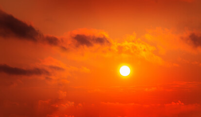 red sky with sun and clouds
