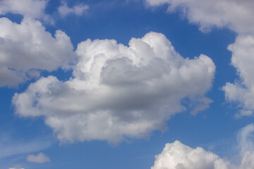 Naklejka na ściany i meble Сumulus clouds in a sunny summer day.