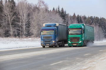 Trucks move in winter on a snowy road