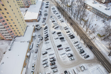 Cars in the parking lot in winter in the city.