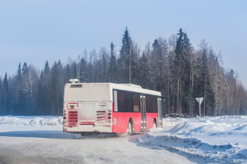 bus moves in winter on a snow-covered road