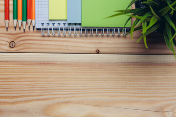 colorful notepads and pencils stationery wooden background close-up