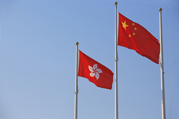 the hong kong flag and chinese flag against the sky
