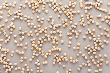 Legumes are scattered in the background, natural background of chickpeas, top view