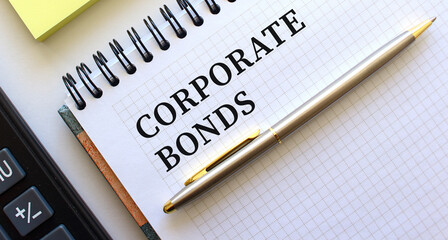 Notepad with text CORPORATE BONDS, next to it lies a calculator. Business concept.