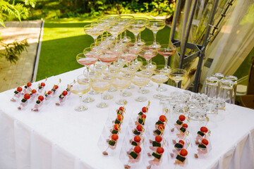 Naklejka na ściany i meble Buffet table. Glasses of champagne and treats