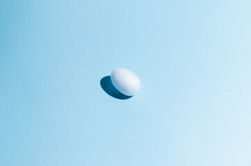 Easter egg on light blue background. Happy Easter concept. Minimal concept. Flat lay. Top view.