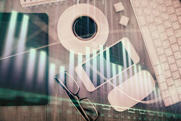 Multi exposure of forex graph hologram over desktop with phone. Top view. Mobile trade platform concept.