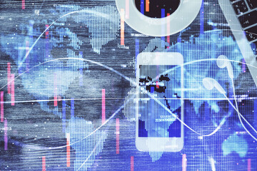 Double exposure of business theme hologram over desktop with phone. Top view. Mobile international trade connection concept.