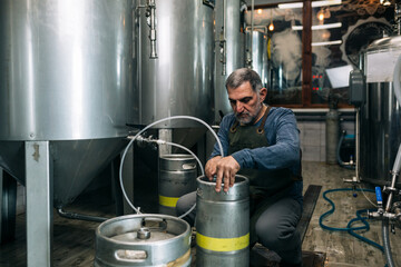 brewer working in his mini craft brewery
