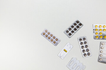 medicines in the form of tablets capsules on a white background top view
