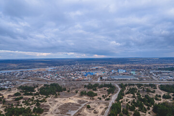 Fototapeta premium Dark clouds over the city in spring with drone