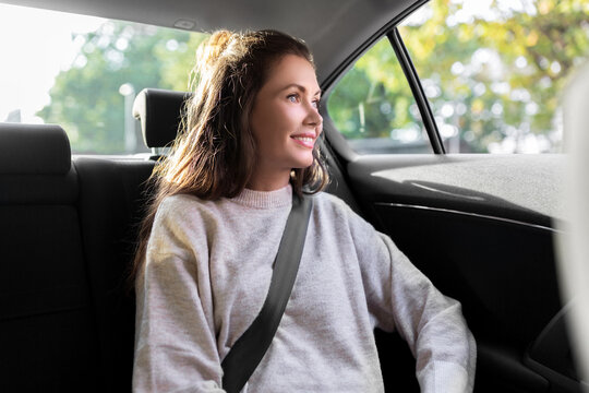 transport, vehicle and people concept - happy smiling woman or female passenger in taxi car