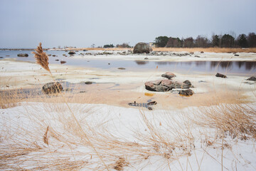 Snow-covered seashore on cold spring morning in Estonia - 417811791