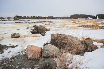 Snow-covered seashore on cold spring morning in Estonia - 417812516