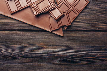 broken chocolate bar diagonal cubes texture wood background