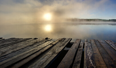 Naklejka na ściany i meble Panorama landscape view of misty sunrise in beautiful lake surrounded by forest
