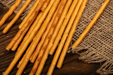 Salty bread strips scattered on a background of coarse homespun fabric.