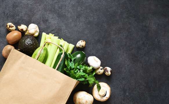 Vegan Food Shopping Or Delivery Concept, Fresh Green  Produce In A Paper Bag.