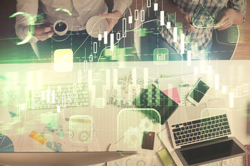 Double exposure of man and woman working together and financial chart hologram drawing. market analysis concept. Computer background. Top View.