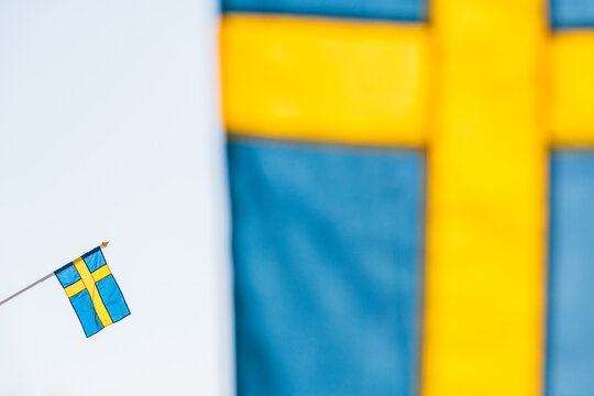 Swedish flag behind another flag